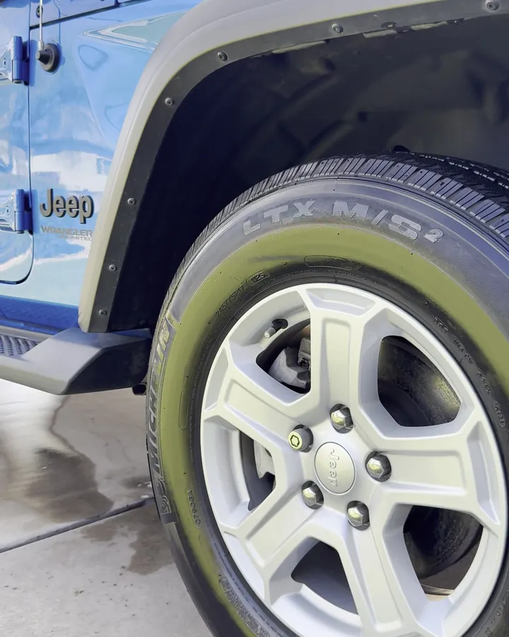 Jeep Wrangler wheel and tire deep-cleaned and dressed after detailing